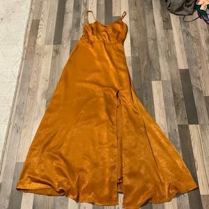 rust colored floor length dress with slit